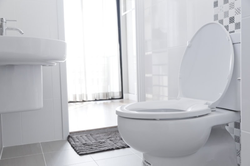 White toilet in white bathroom.